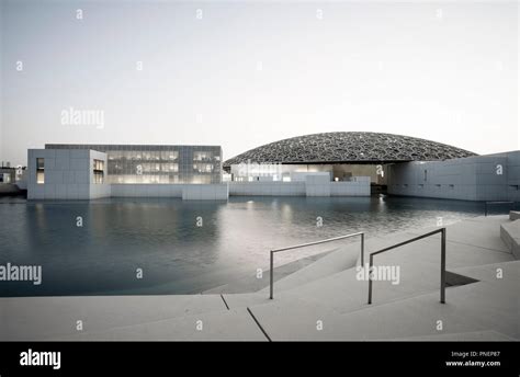 Exterior evening view of the Louvre Abu Dhabi at Saadiyat Island ...