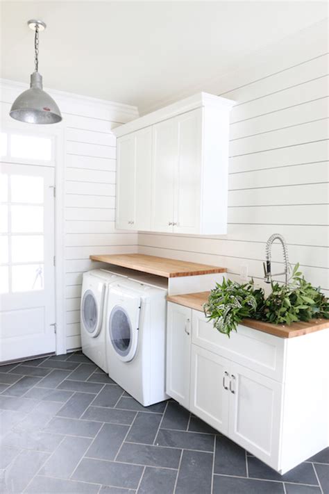 Stunning laundry room features walls clad in white paneling painted Benjamin Moore Simply White ...