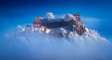 Photographer Snaps a Snow-capped Stirling Castle Shrouded in Mist at Sunset