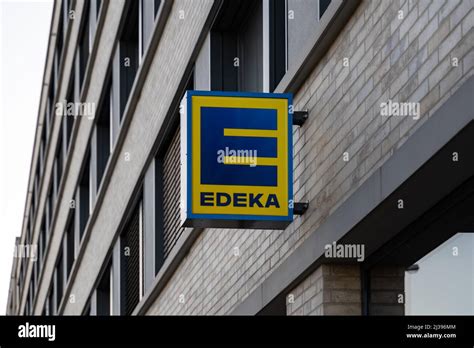 Edeka supermarket company logo on a facade of a building. Sign of a big ...