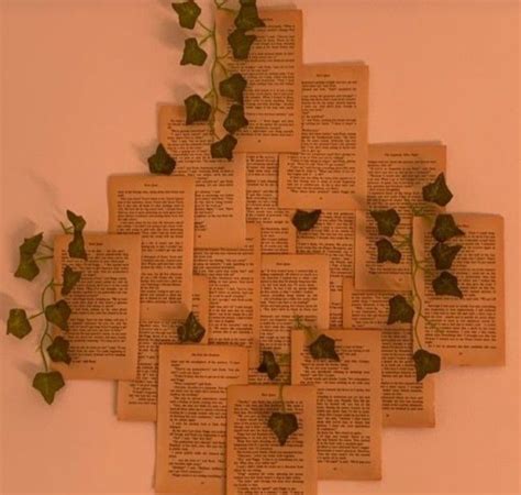 a clock made out of old books with ivys on the sides and words reading play