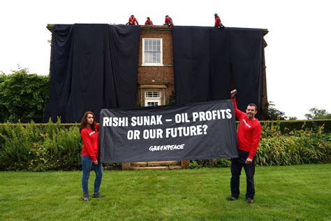 Greenpeace oil protesters cover Rishi Sunak's home in black fabric ...