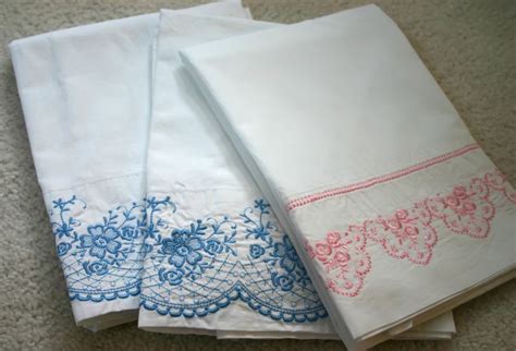 three white napkins with blue and pink designs on them sitting on the ...