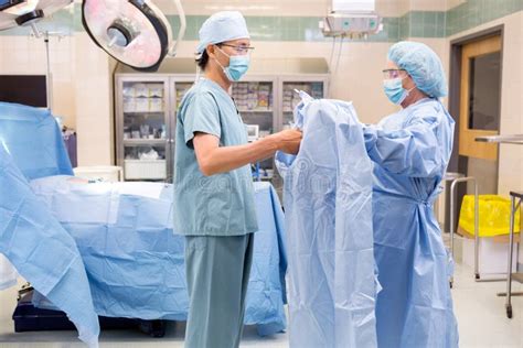 Scrub Nurse Assisting Surgeon with Gown Stock Image - Image of ...