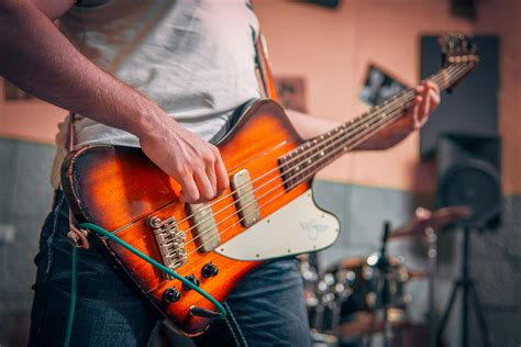 Man in White T-shirt Playing Brown Electric Guitar · Free Stock Photo