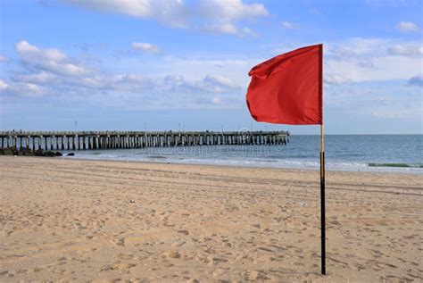 Red Flag at the Beach stock image. Image of turf, beaches - 16680423