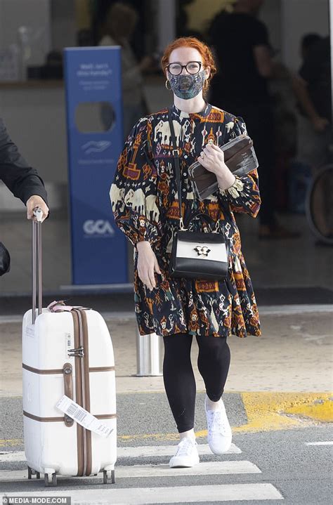 Ex Wiggles star Emma Watkins dons a retro frock as she arrives solo at Gold Coast Airport ahead ...