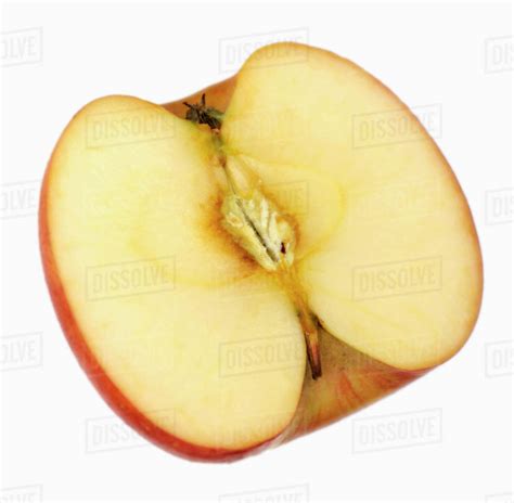 Half a 'Pink Lady' apple - Stock Photo - Dissolve