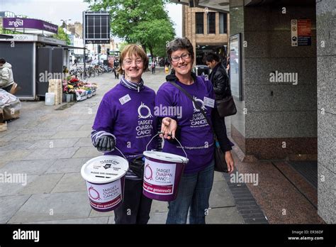 Two cheerful charity workers collecting donations for Target Ovarian Cancer Stock Photo - Alamy