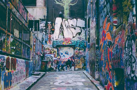 Colorful grunge graffiti artwork covering walls in alleyway with skull in Hosier Lane | Street ...