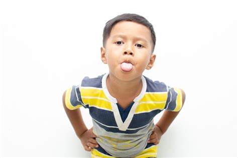 Premium Photo | Asian little boy sticking his tongue out