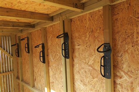 Hooks in a vertical bike shed | Shed storage, Bike shed, Shed storage ideas bikes