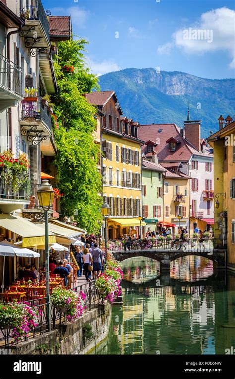 Lake Annecy running through the pretty alpine town of Annecy in southeastern France Stock Photo ...