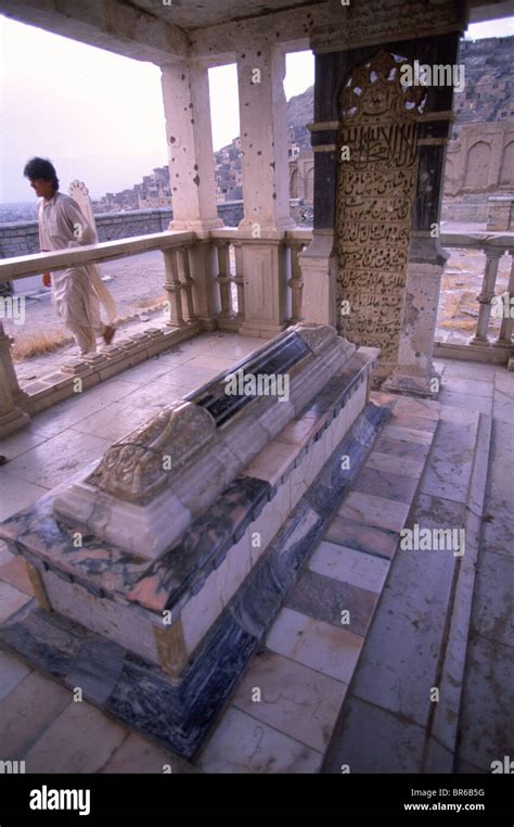 A man walks by the marble tomb of Babur in the Babur Gardens Kabul ...