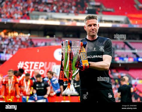 Luton Town manager Rob Edwards poses for a photo with the trophy after ...