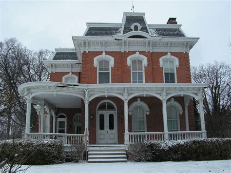 a large red brick house with white trim