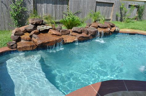 This small pool and spa in Katy Tx (Houston, TX) features stamped overlay concrete deck in an a ...