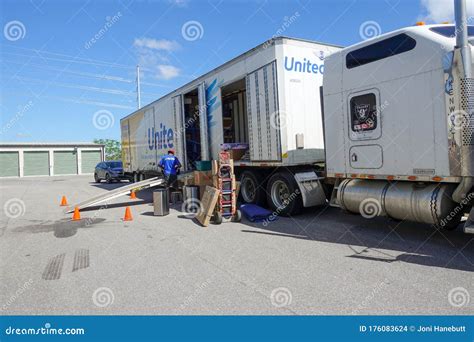 A United Van Lines Moving Truck with the Mover Unloading the Truck ...