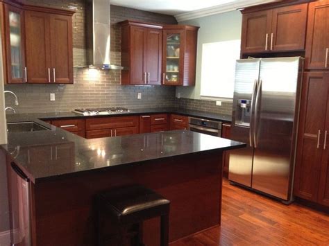 grey glass subway tile backsplash with cherry cabinets and black countertops - Google S ...