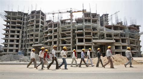 File picture shows workers walking in front of the construction site of ...