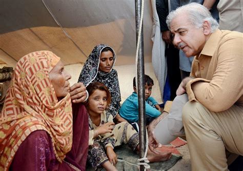 Chief Minister Shahbaz Sharif with a family in food camp of Garh ...