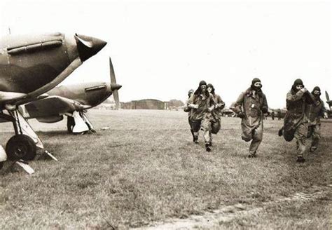 Pilots of No 79 Squadron RAF scramble for their Hurricane Mk I fighters ...