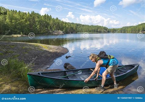 Woman canoeing on the lake stock image. Image of backpacker - 154501907