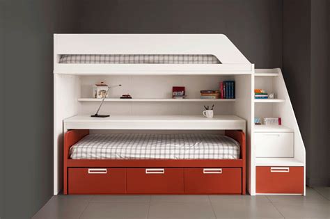 a white bunk bed sitting next to a red and white dresser under a stair case