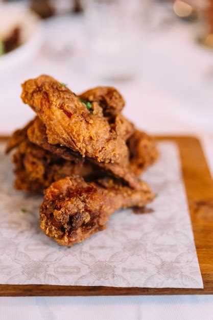 Premium Photo | Hot and crispy golden fried chicken wings and wingsticks