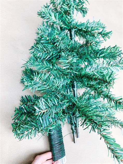 wrapping wire to connect two dollar tree trees together | Dollar tree christmas, Mini christmas ...