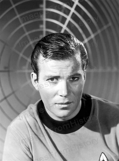 a man in a star trek uniform poses for a portrait with a futuristic background behind him