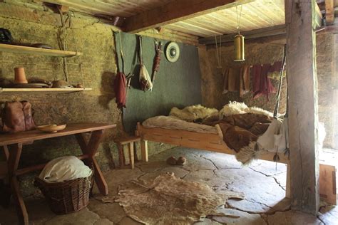 an old fashioned bedroom with stone floors and walls