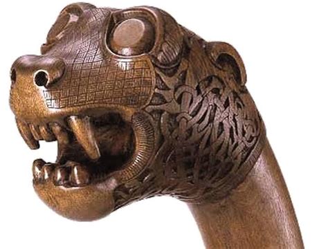 a wooden carving of a bear with its mouth open