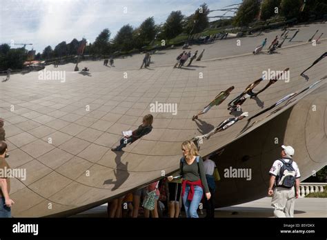 The Chicago Bean with people looking at their reflections Stock Photo - Alamy