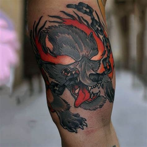 Old school colored little demonic dog tattoo on biceps with chain - Tattooimages.biz