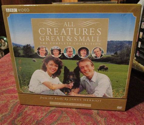 the dvd cover for all creatures, great and small is sitting on top of a table