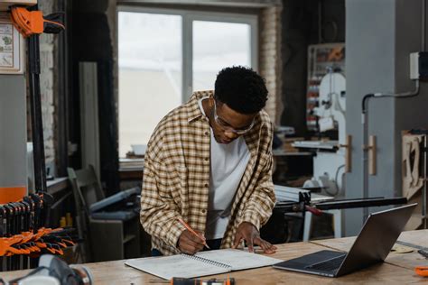 A Man Writing on the Notebook · Free Stock Photo