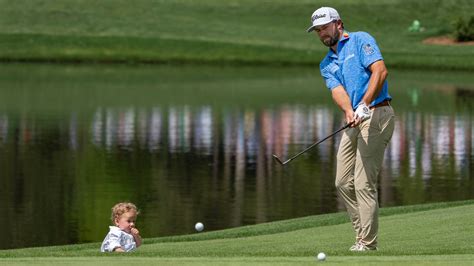 Cameron Young chips to the No. 5 green as his son, Henry, watches ...