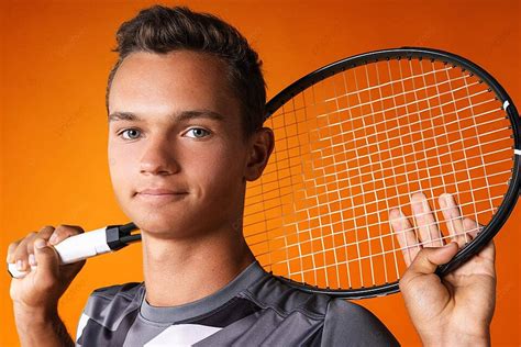 A Tennis Players Portrait Captured Against An Orange Background Photo ...