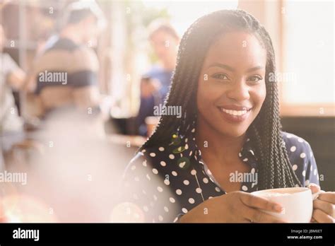 Portrait smiling African woman drinking cappuccino in cafe Stock Photo ...