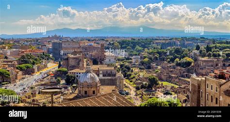 Rooftop view of the foro romano in the foreground and the famous ...