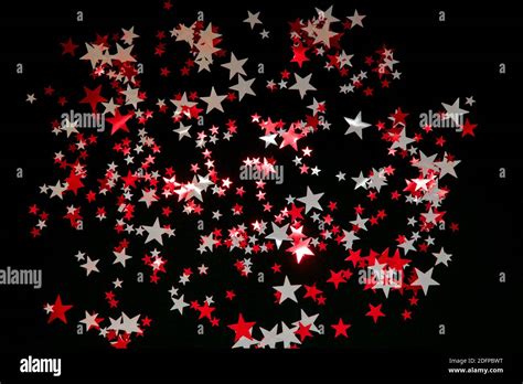 Bright red and white stars confetti on black background. Holidays concept Stock Photo - Alamy