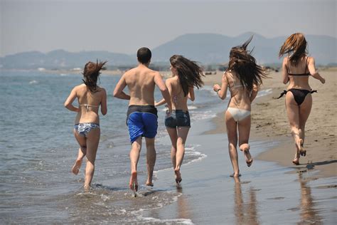 happy people group have fun and running on beach 12645452 Stock Photo at Vecteezy