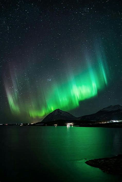 Aurora Borealis over Snow Capped Mountains