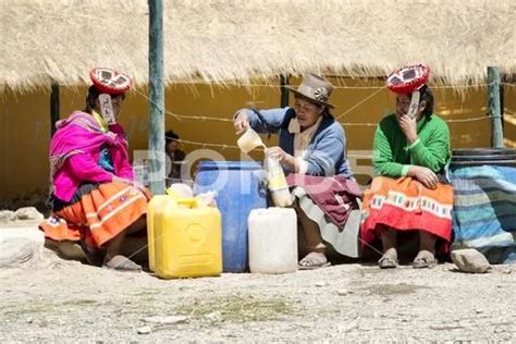 Indigenous women selling chicha (fermented corn beer) at the market Stock Image #72706531