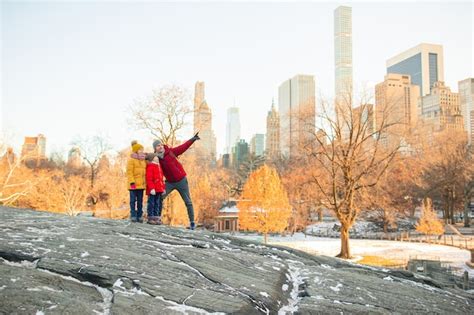 Premium Photo | Family of father and kids in central park during their ...