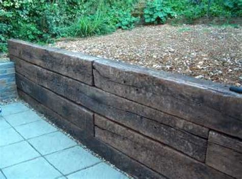 A simple retaining wall using reclaimed railway sleepers, available at ...