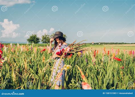 Gorgeous Young Woman Picking Flowers in a Field Stock Image - Image of ...