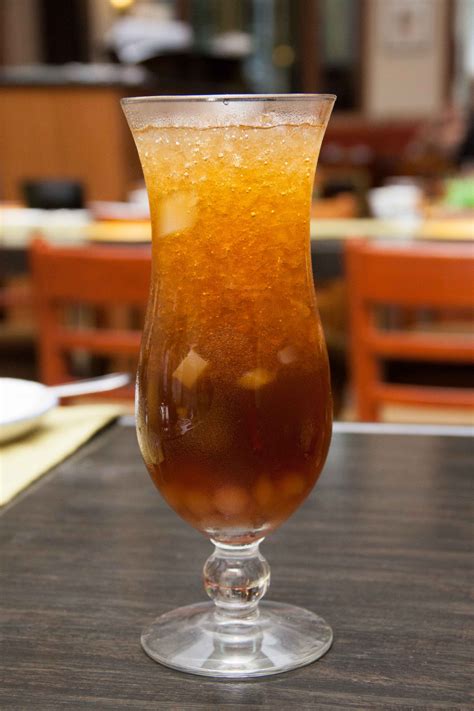 a glass filled with liquid sitting on top of a table