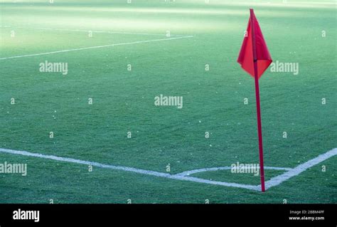 Soccer field with a corner red flag and flag pole Stock Photo - Alamy